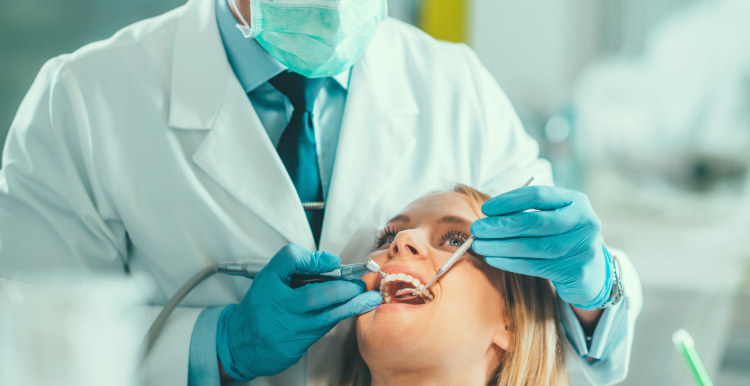 Dentist checking patient's teeth