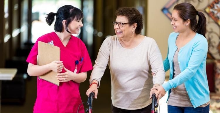 patient with mobility aid and relative talking to nurse
