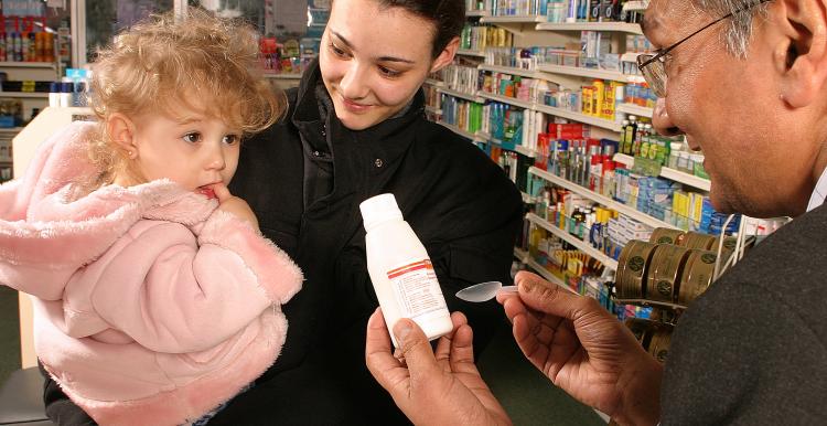 pharmacist talking to mum and daughter