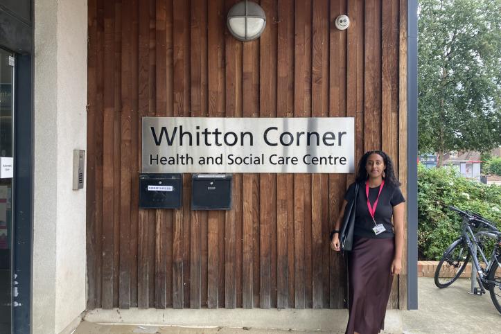 Intern standing visiting a local service