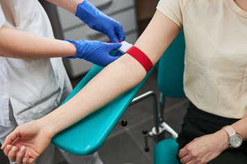 A patient is having their blood drawn by a healthcare professional.