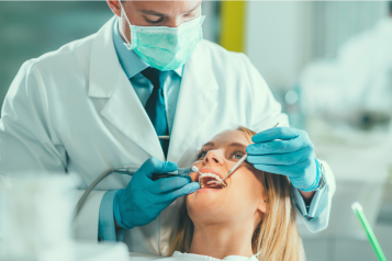 Dentist checking patient's teeth