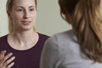 A patient speaking to mental health professional