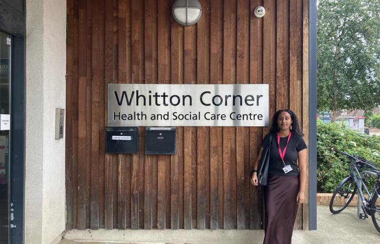 Intern standing visiting a local service