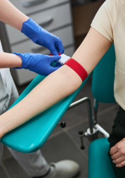 A patient is having their blood drawn by a healthcare professional.