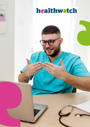 Photo of a man wearing blue scrubs, sitting at his desk, signing in BSL at his laptop screen. There is a stethoscope and a notebook on his desk. On the top right corner there is the Healthwatch logo. 