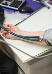 Patient having their blood pressure taken by their GP